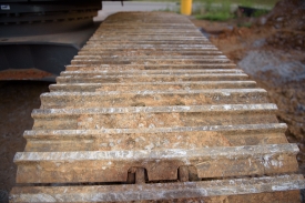 Excavator Heavy construction equipment closeup tracks with dirt 