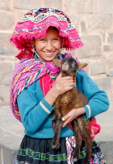 girl in traditional dress holding baby alpaca cuzco peru 011