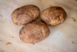 whole potatos on with paper background photo