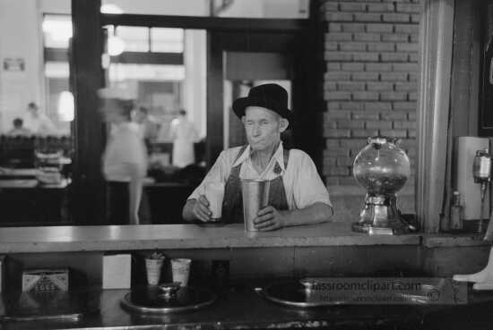 Man drinking malted milk at stand in streetcar terminal Oklahoma