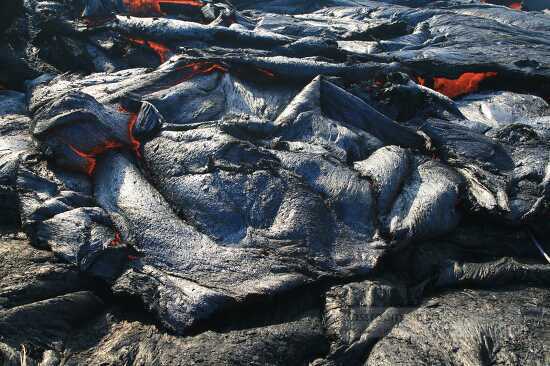 Sluggish pahoehoe briefly spills over a section the levee