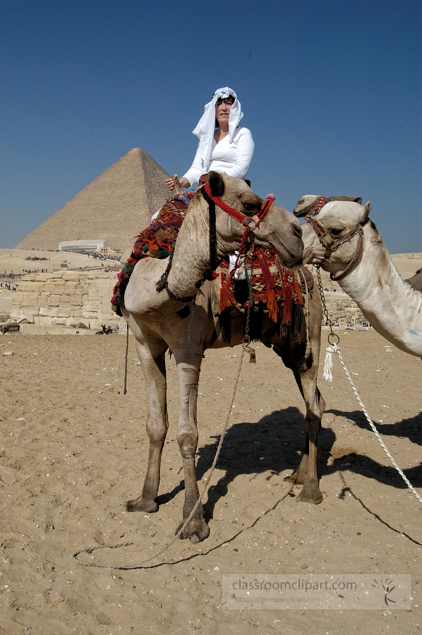 tourist riding a camel near great pyramids cairo egypt