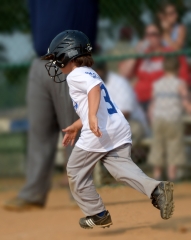little league player running to base