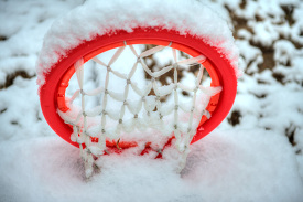 snow covered childrens basketball hoop