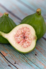 Two Whole Green Figs With Sliced Fig In Front 
