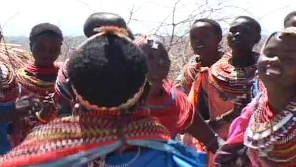 africa women wearing beads brightly colored clothing dancing video