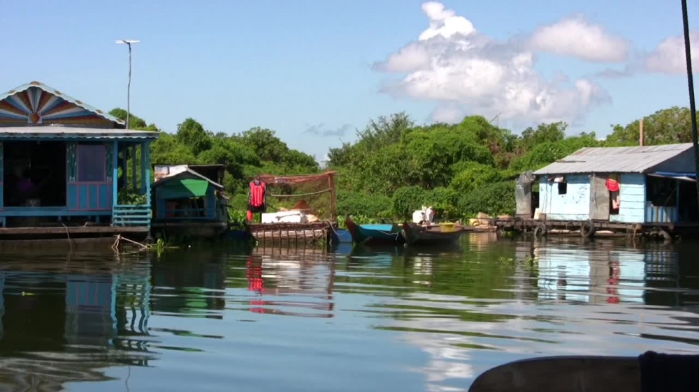 house boats docked along river cambodia