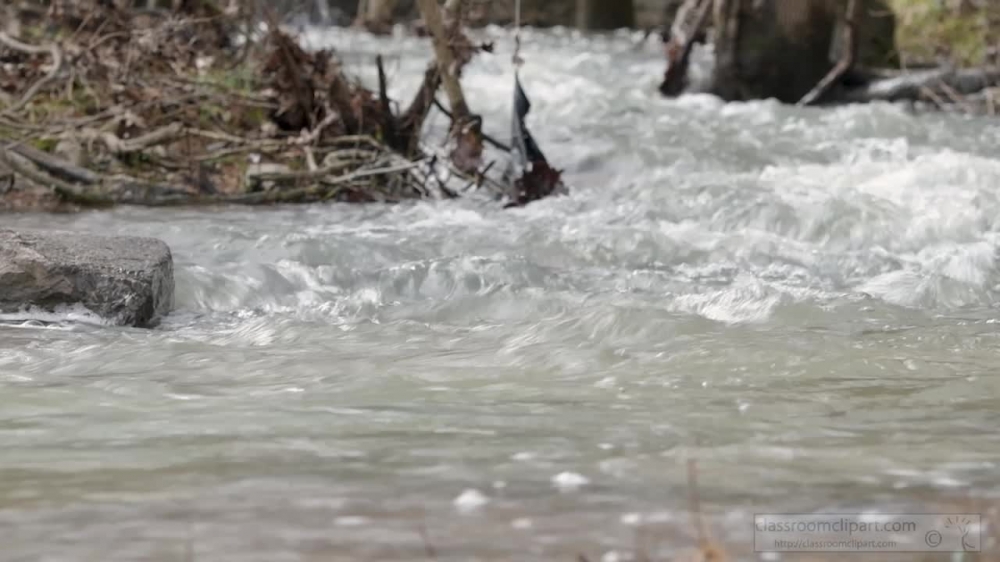 slow motion video moving water in creek after rain