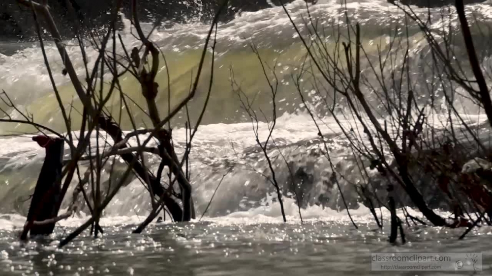 slow motion video moving water in creek after rain