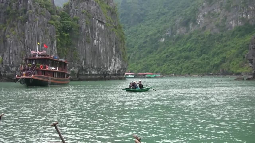 small boat with locals halong bay vietnam