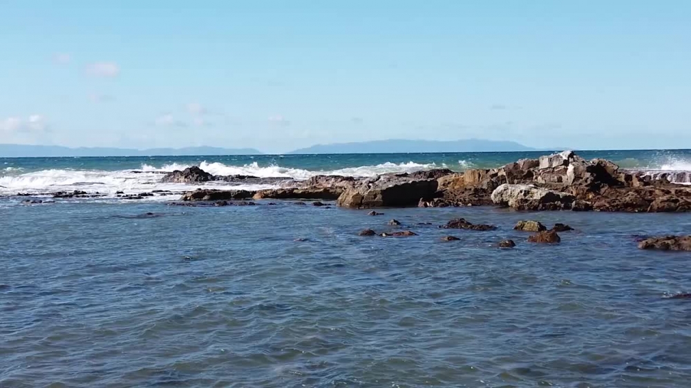 waves crashing on a rocky shore in california