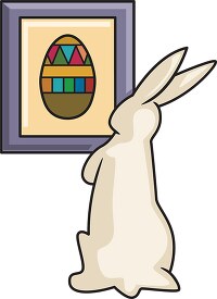 easter bunny looking at picture of decorated egg
