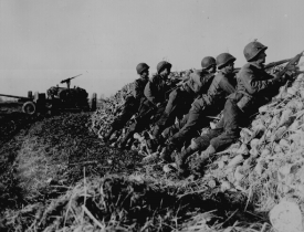 A U S Infantry anti-tank crew fires on Nazis