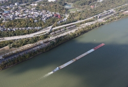 Aerial view of a tugboat pushing barges upstream on the Ohio Riv