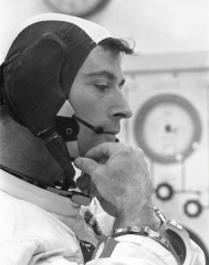Apollo 10 Command Module Pilot Young adjusts strap on communications cap