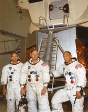 apollo 11 astronauts in front of lunar module mockup