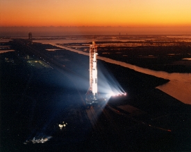 apollo 13 bathed in floodlight during early morning rollout