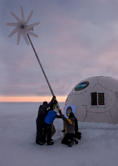 assemble a wind powered turbine to supply some of ice camp sargo