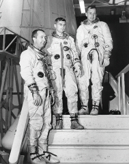 Astronauts pose on the steps leading to Apollo mocku