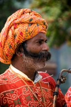 bearded man wearing turbin and colorful indian clothing india