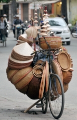 Bicycle loaded with baskets and hats for sale