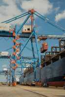 cargo crane loads a container onto a cargo ship port baltimore
