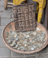 ceramic bowl filled with old coins at souk market marrakesh moro