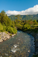 clear river water green mountain blue sky chile