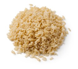 cooked brown rice on white background