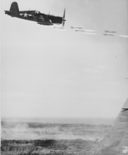 Corsair fighter looses its load of rocket projectiles Okinawa