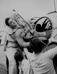 Crewmen lifting Kenneth Bratton out of turret