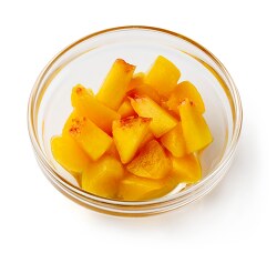 diced peaches in clear bowl