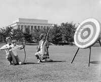family holding bow and arrows practicing archery 1929
