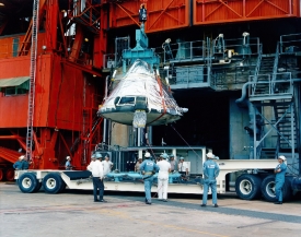 fire-ravaged Apollo 204 command module is lowered from the gantr