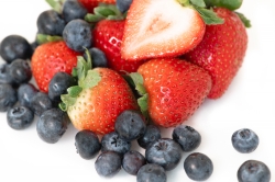 fresh blueberries and strawberries white background