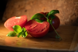 fresh sliced tomatoes with basil leaves