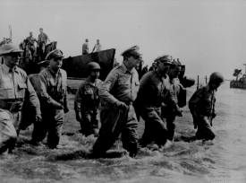 Gen Douglas MacArthur wades ashore
