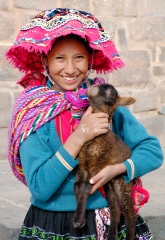 girl in traditional dress holding baby alpaca cuzco peru 012