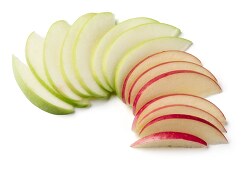 Green and red apple slices on white background