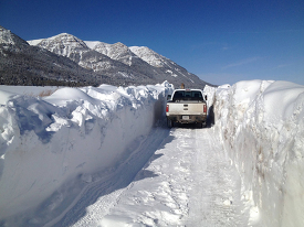 high snow banks on snow covered roadway