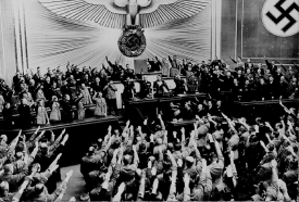 Hitler accepts the ovation of the Reichstag after announcing the peaceful acquisition of Austria