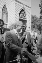 Jimmy Carter shaking hands after leaving a church in Jacksonvill
