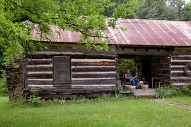 John Herbert weaves baskets in a dogtrot log cabin Cherokee Alab