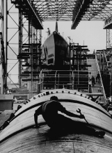 Man working on hull of U.S submarine