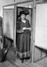 Margaret Lally at the door of a voting booth during the first el