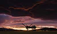 MQ-9 Reaper sits on the flightline as the sun sets
