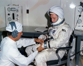 NASA suit technician assists astronaut White