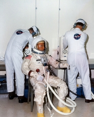 NASA suit technicians assists astronaut Grissom
