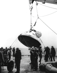 Navy personnel hoist the Apollo 7 spacecraft aboard the USS Esse