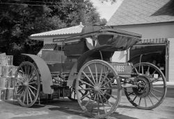 Old horseless carriage at gasoline station